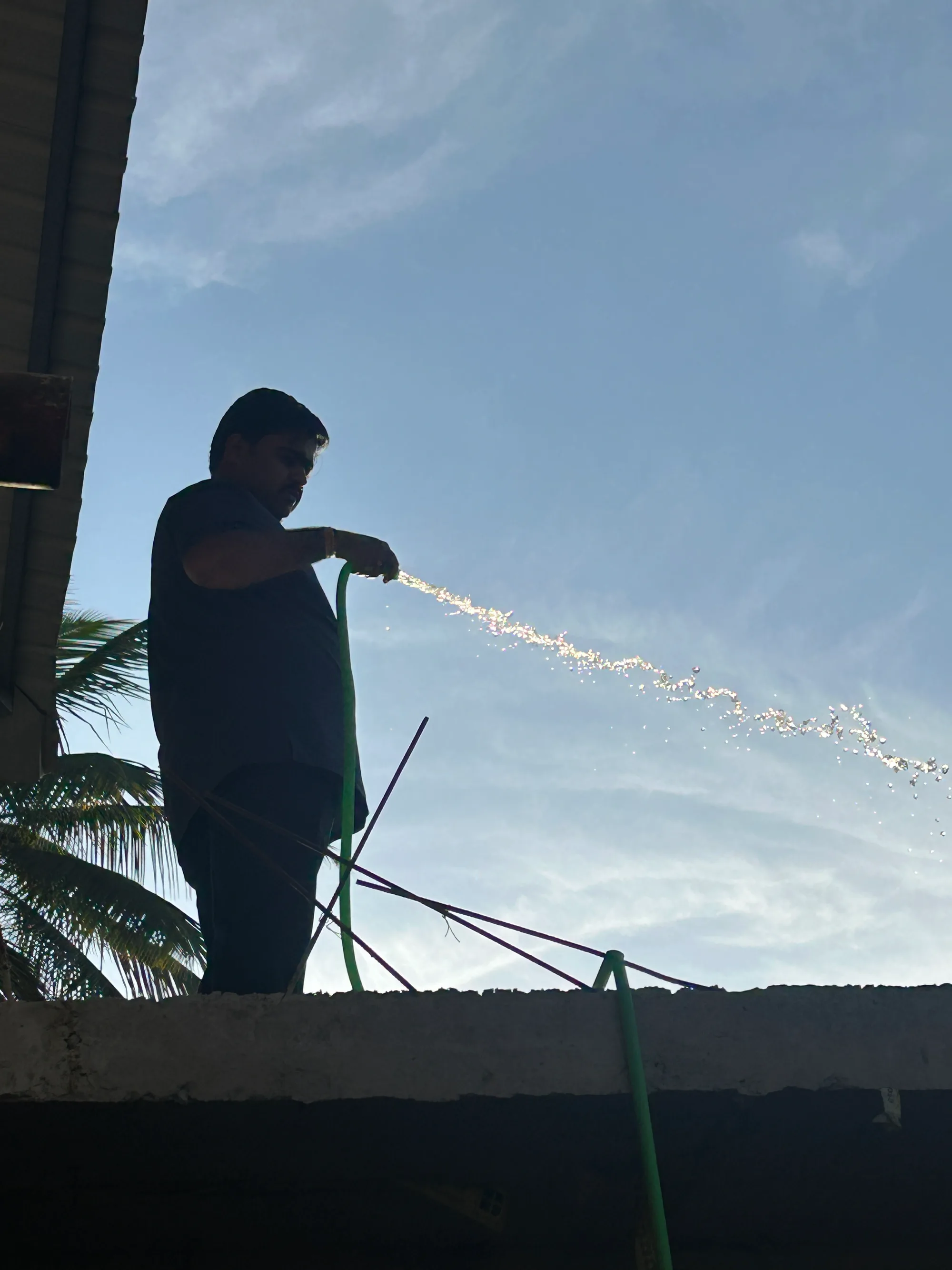 Site photograph during construction: curing the slab with a hose